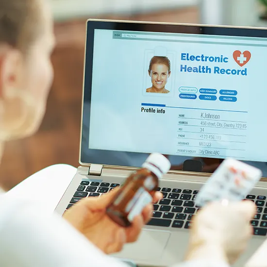 Medical professional looking up electronic patient care records on a computer