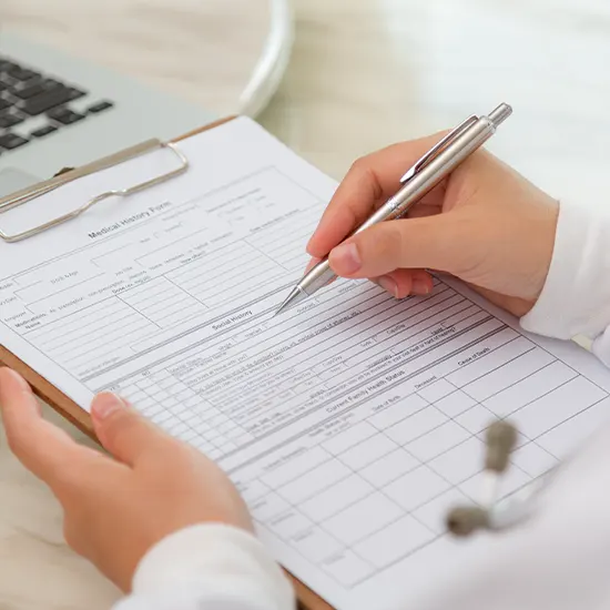 Medical professional's hands making patient care notes